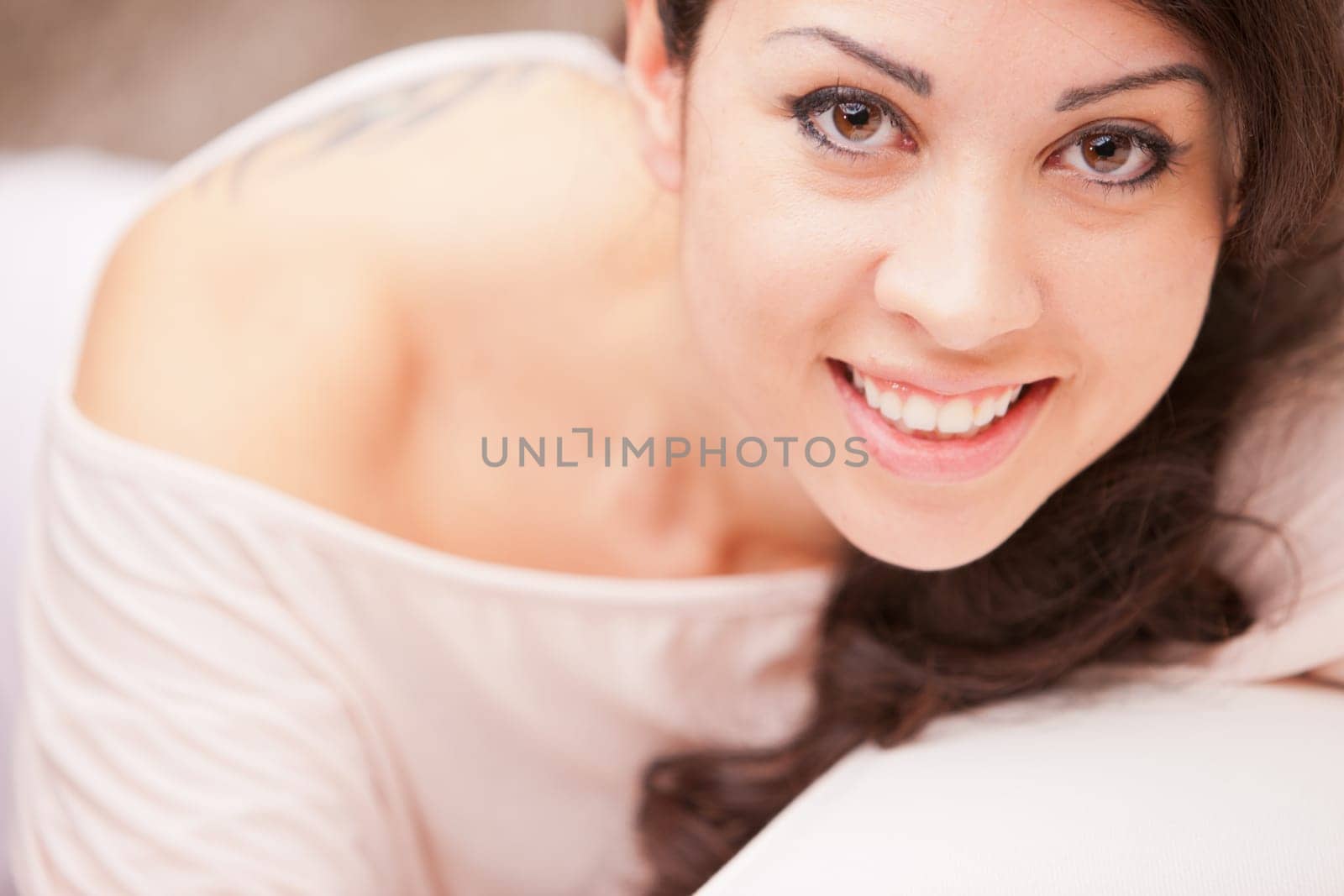 this Italian brunette has big brown eyes and is softly relaxing on this white living room waiting for your AD to be completed