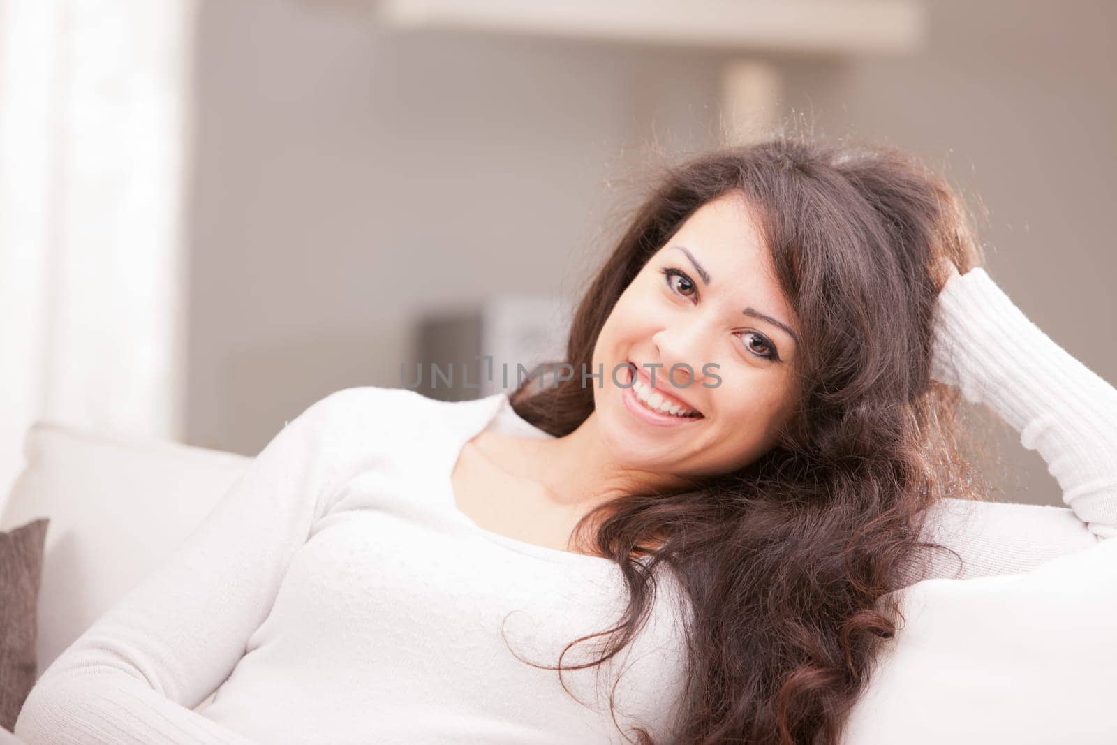 this Italian brunette has big brown eyes and is softly relaxing on this white living room waiting for your AD to be completed