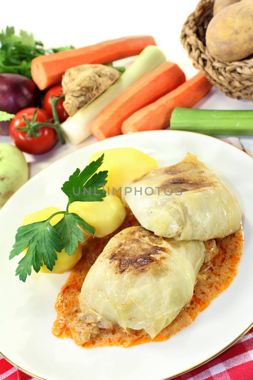 a plate of cabbage roulade and potatoes