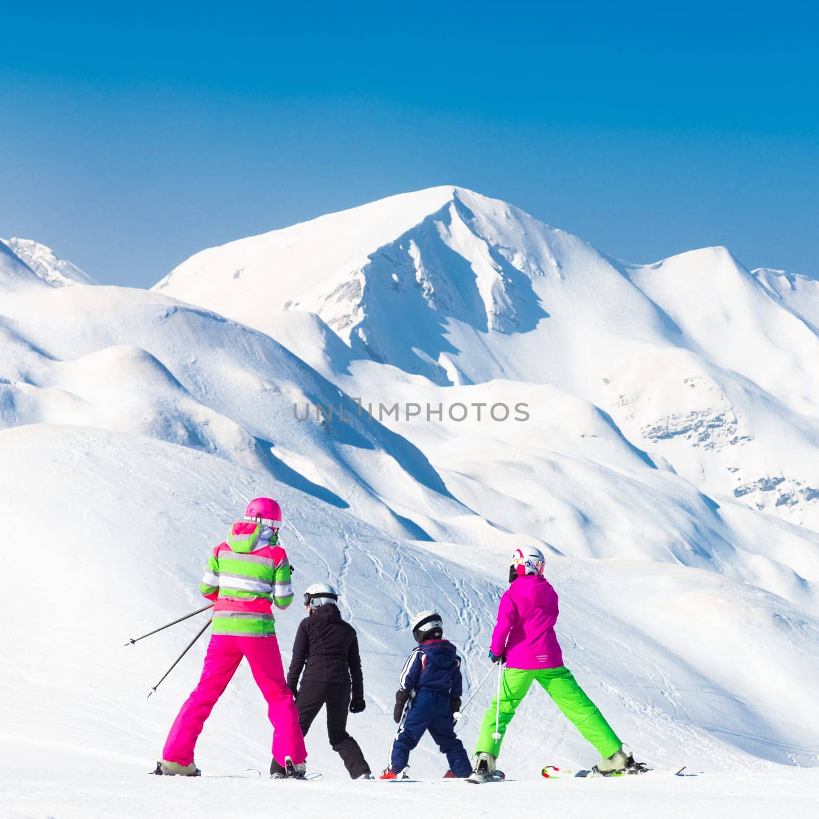 Family on winter ski vacations in ski slopes in Alps, Vogel, Slovenia, Europe.