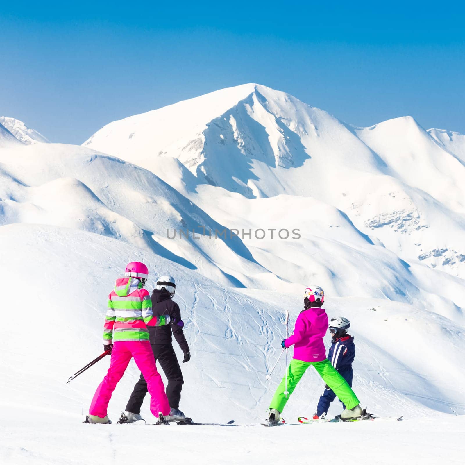 Family on winter ski vacations in ski slopes in Alps, Vogel, Slovenia, Europe.
