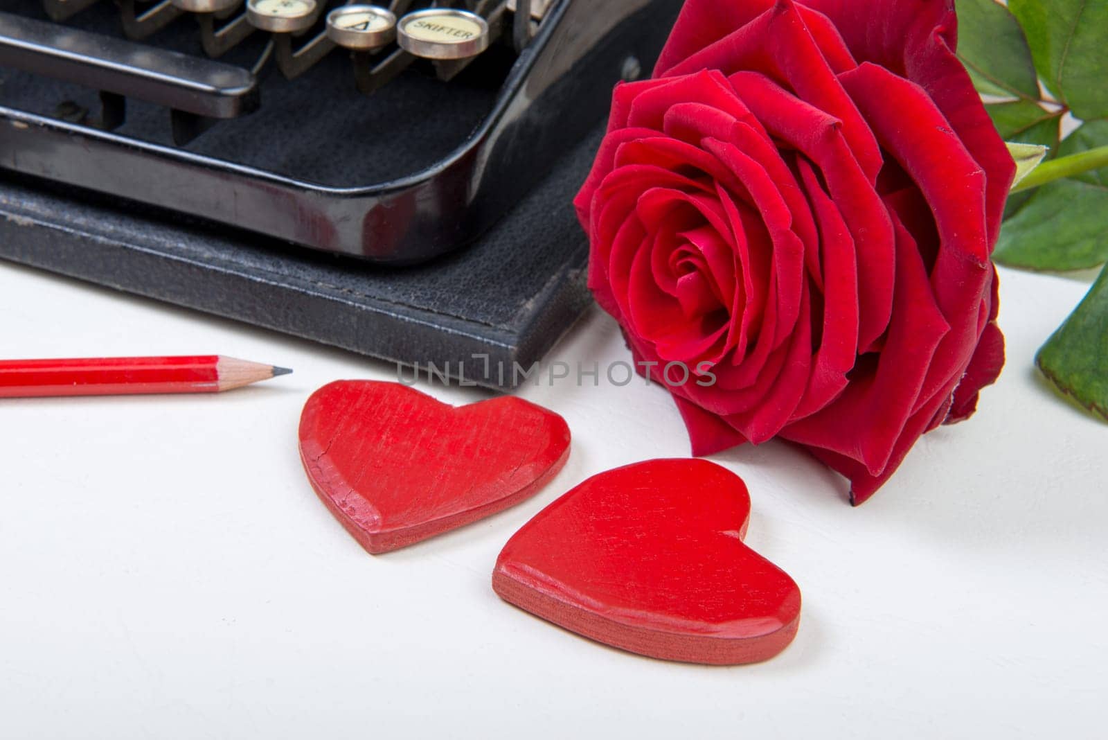 antique typewriter with hearts and rose