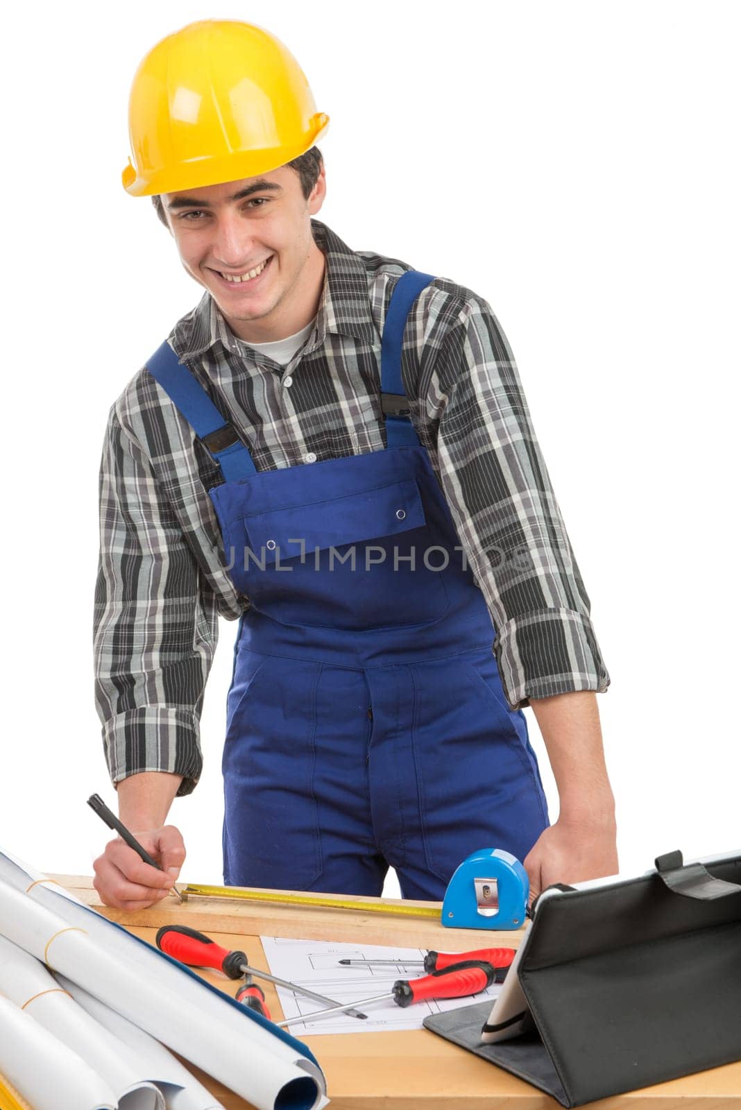 a worker measuring a board with a tape measure