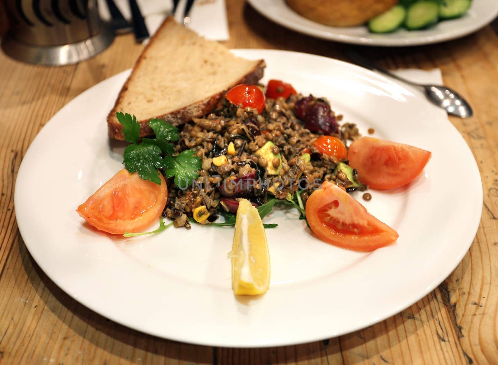 Lentils on a plate with vegetables photographed closeup