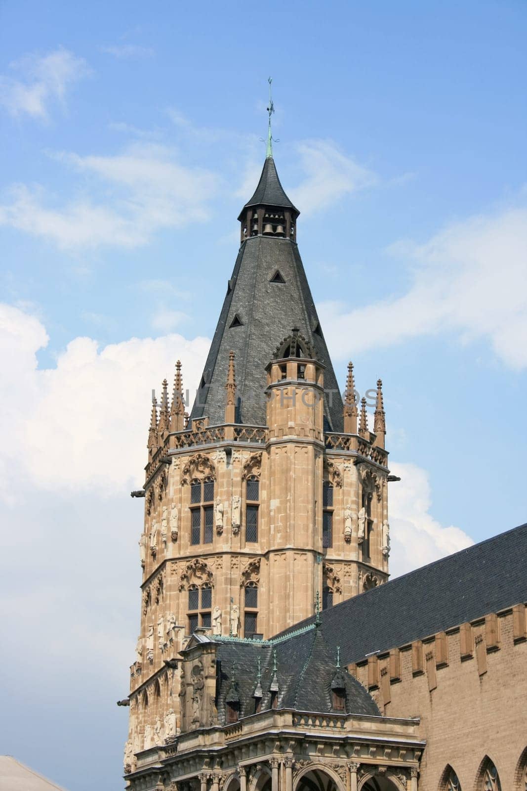 Detailed view of an imposing bell tower,blue sky in background