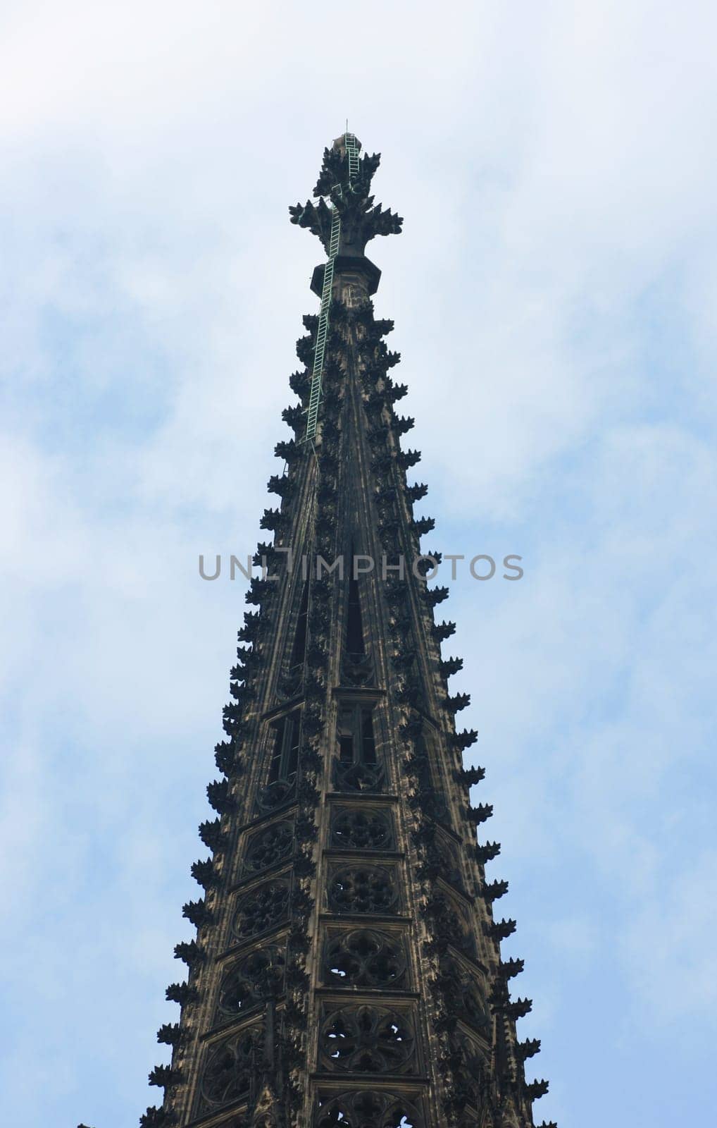 A Beautifully decorated spire,blue sky in the background