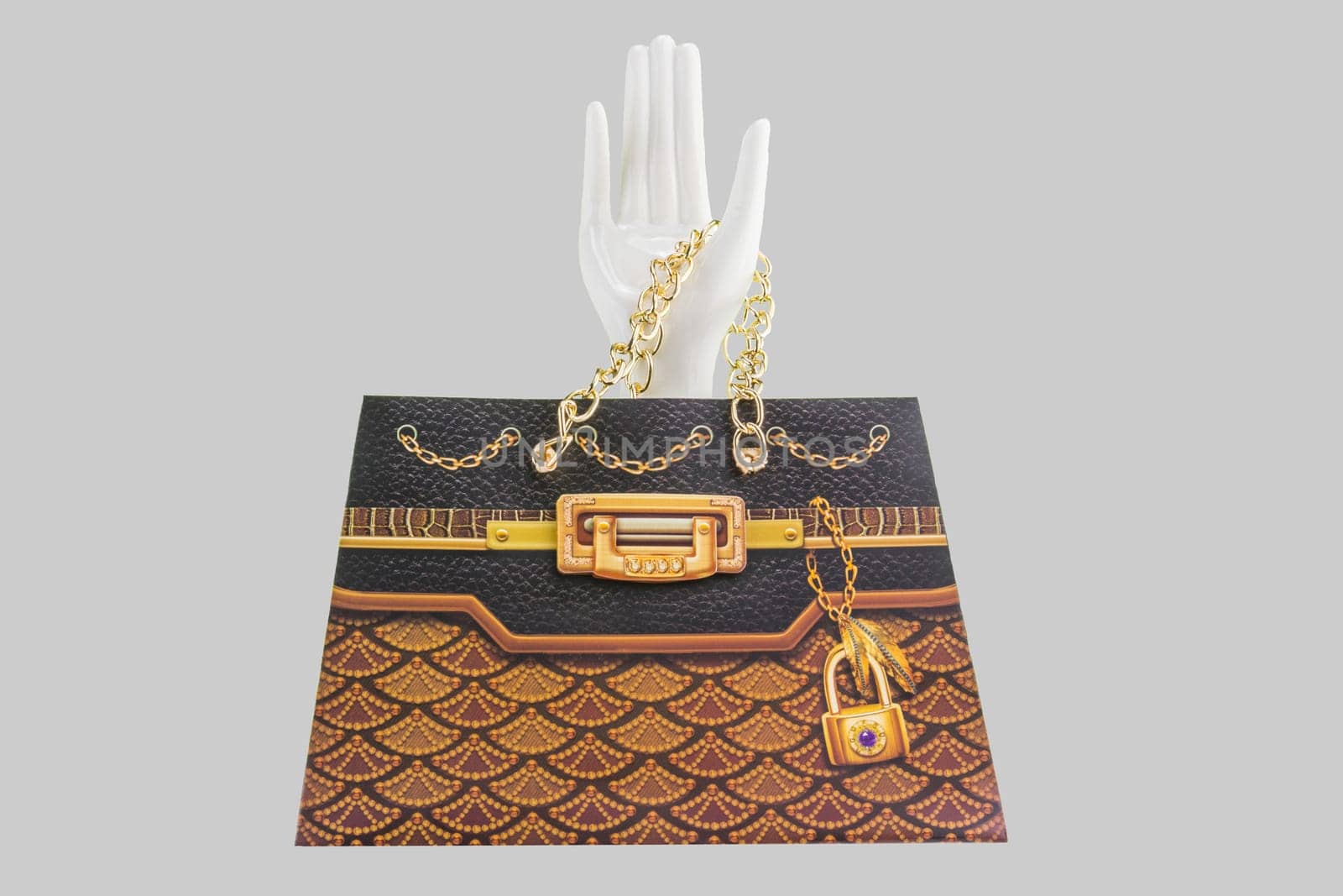 Paper bag presented by white ceramic hand. isolated on grey backround