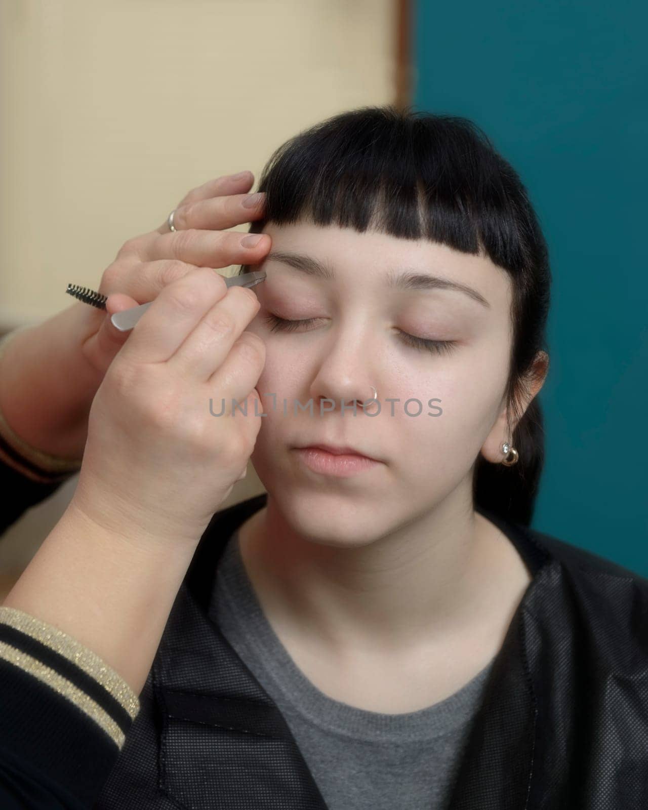 Permanent makeup. Verification of proportions. Cosmetologist applying permanent make up on eyebrows- eyebrow tattoo