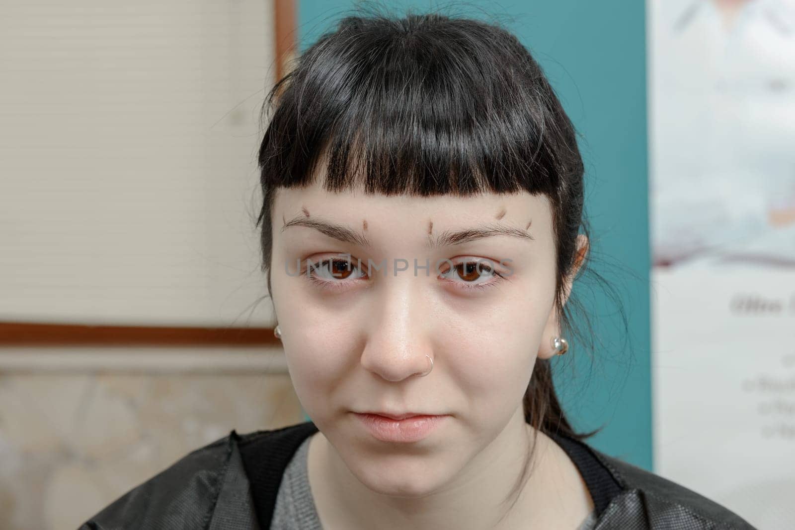 Permanent makeup. Verification of proportions. Cosmetologist applying permanent make up on eyebrows- eyebrow tattoo