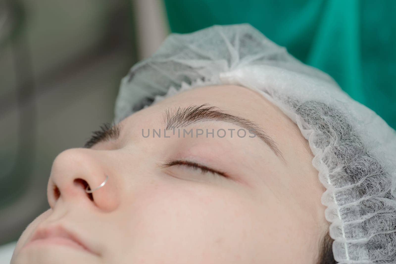 Permanent makeup. Permanent tattooing of eyebrows. Cosmetologist applying permanent make up on eyebrows- eyebrow tattoo