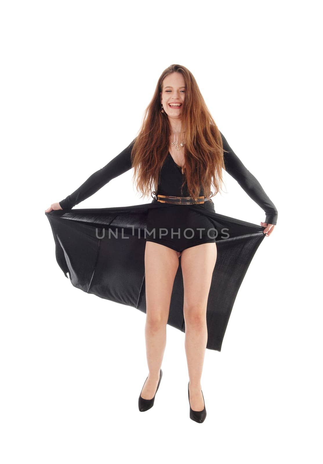 Happy beautiful woman in a long evening dress and long brunette hair.standing lifting her dress sowing shorts, isolated for white background.
