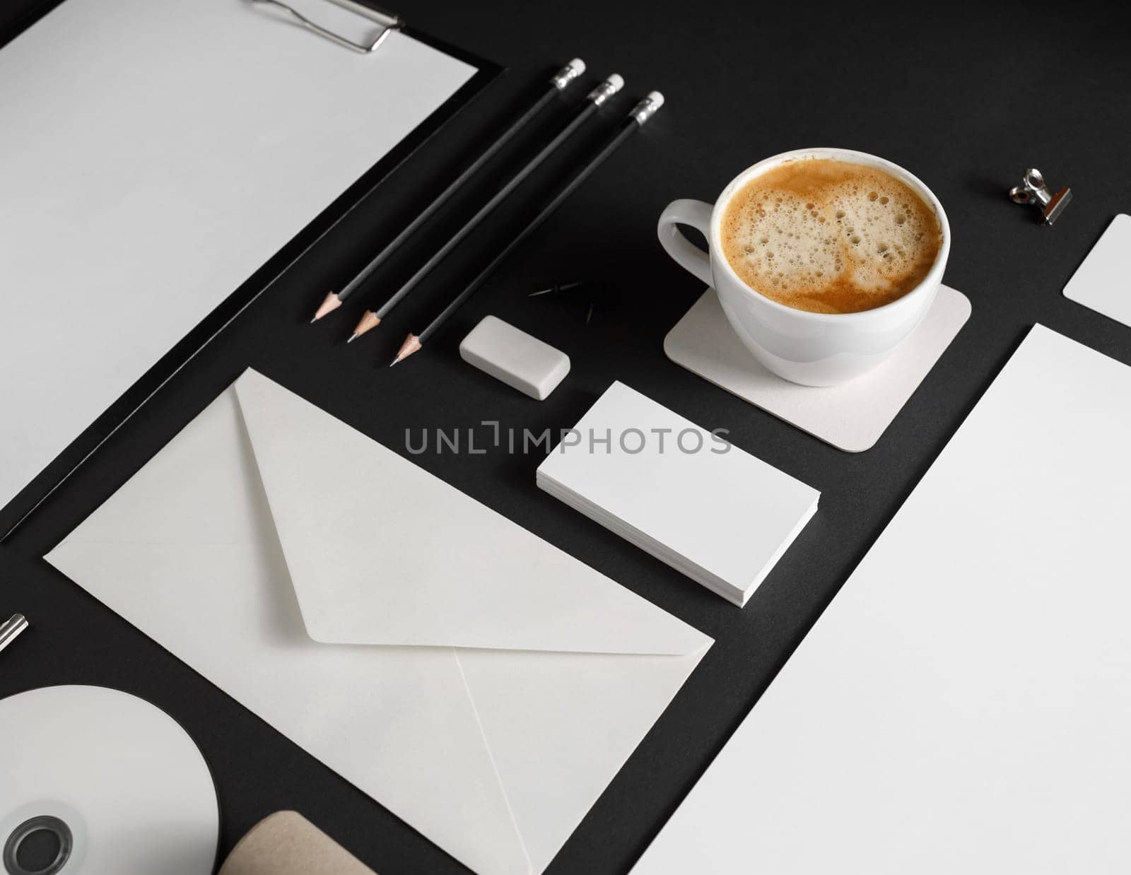 Photo of blank corporate identity set on black paper background. Stationery set.