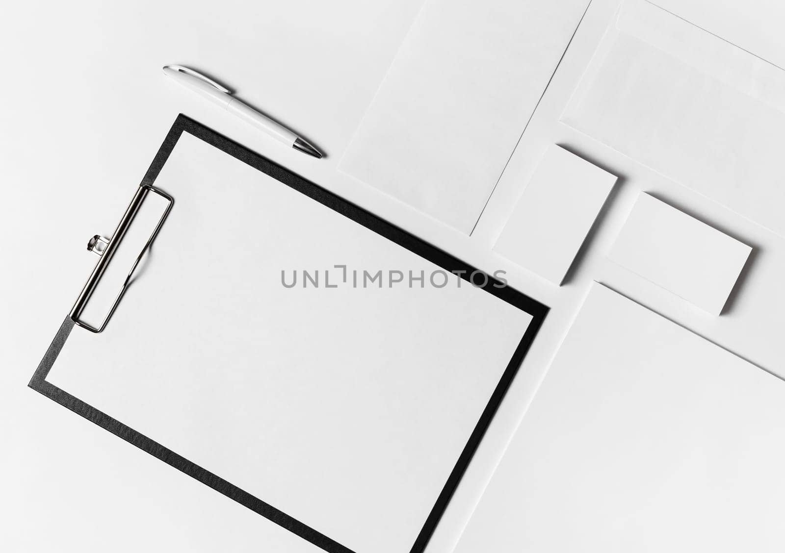 Photo of blank corporate stationery set with plenty of copy space on white paper background. Top view. Flat lay.