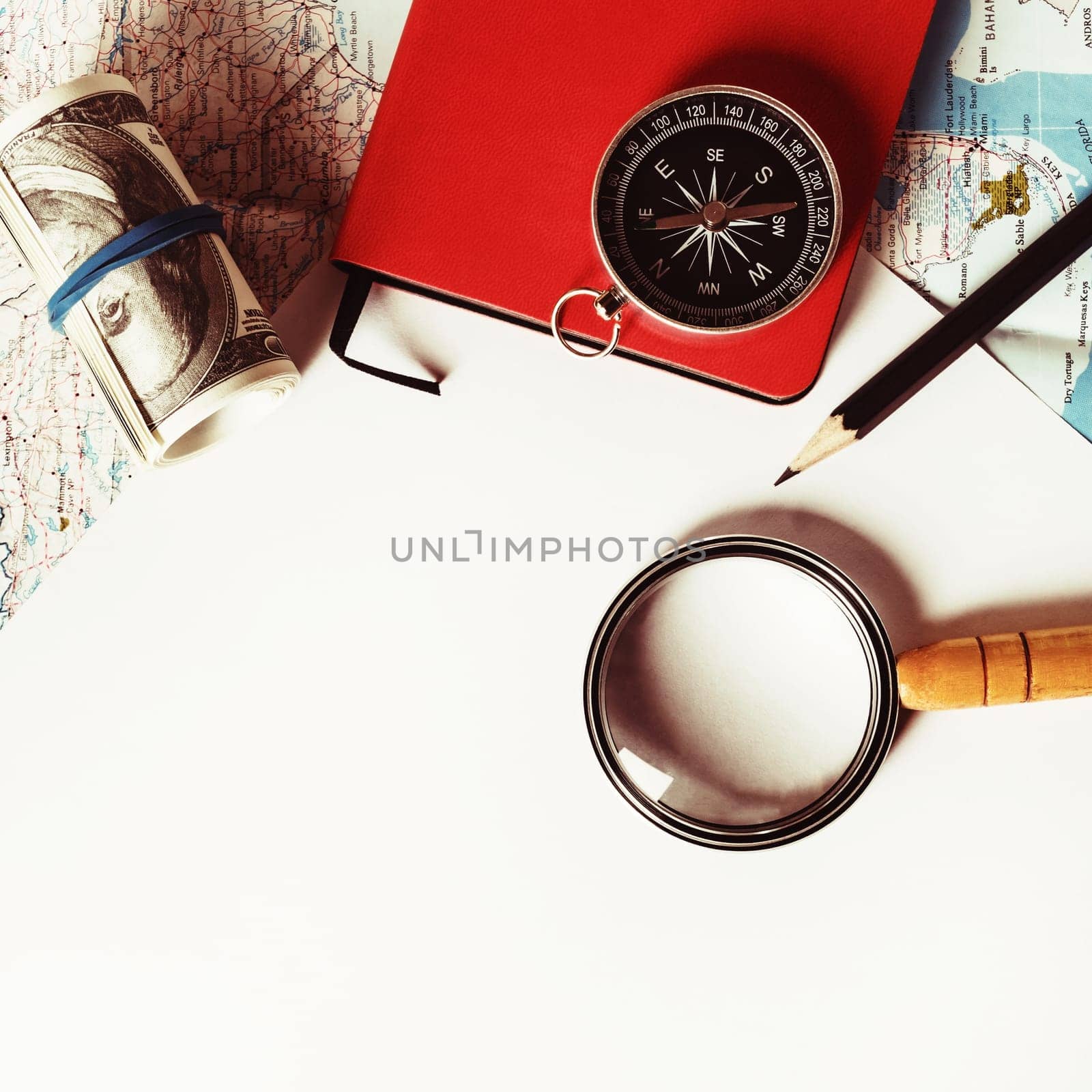 Travel stationery set. Paper, magnifier, map, compass, notebook, money and pencil. Tourism concept. Vintage toned image. Top view. Flat lay.
