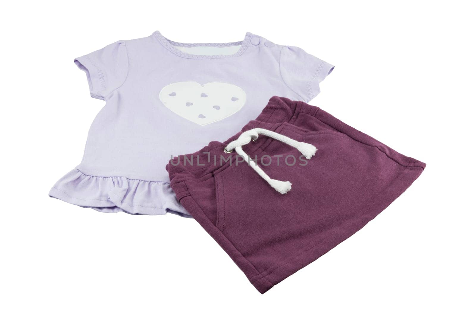 Purple baby shirt or t-shirt with one big and some other hearts in it. Shirt is combined with purple skirt. concept baby fashion. isolated.
