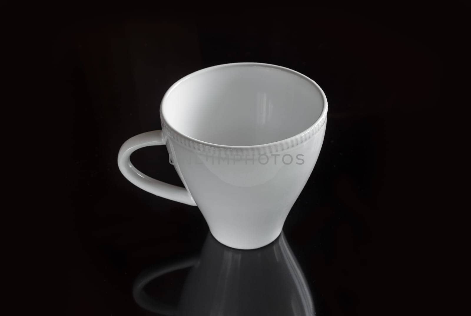 White empty cup on a dark background for a drink