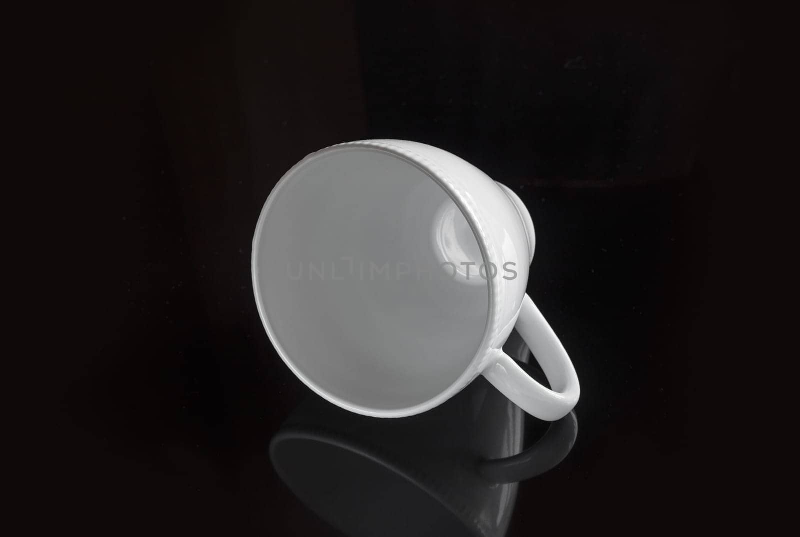 White empty cup on a dark background for a drink