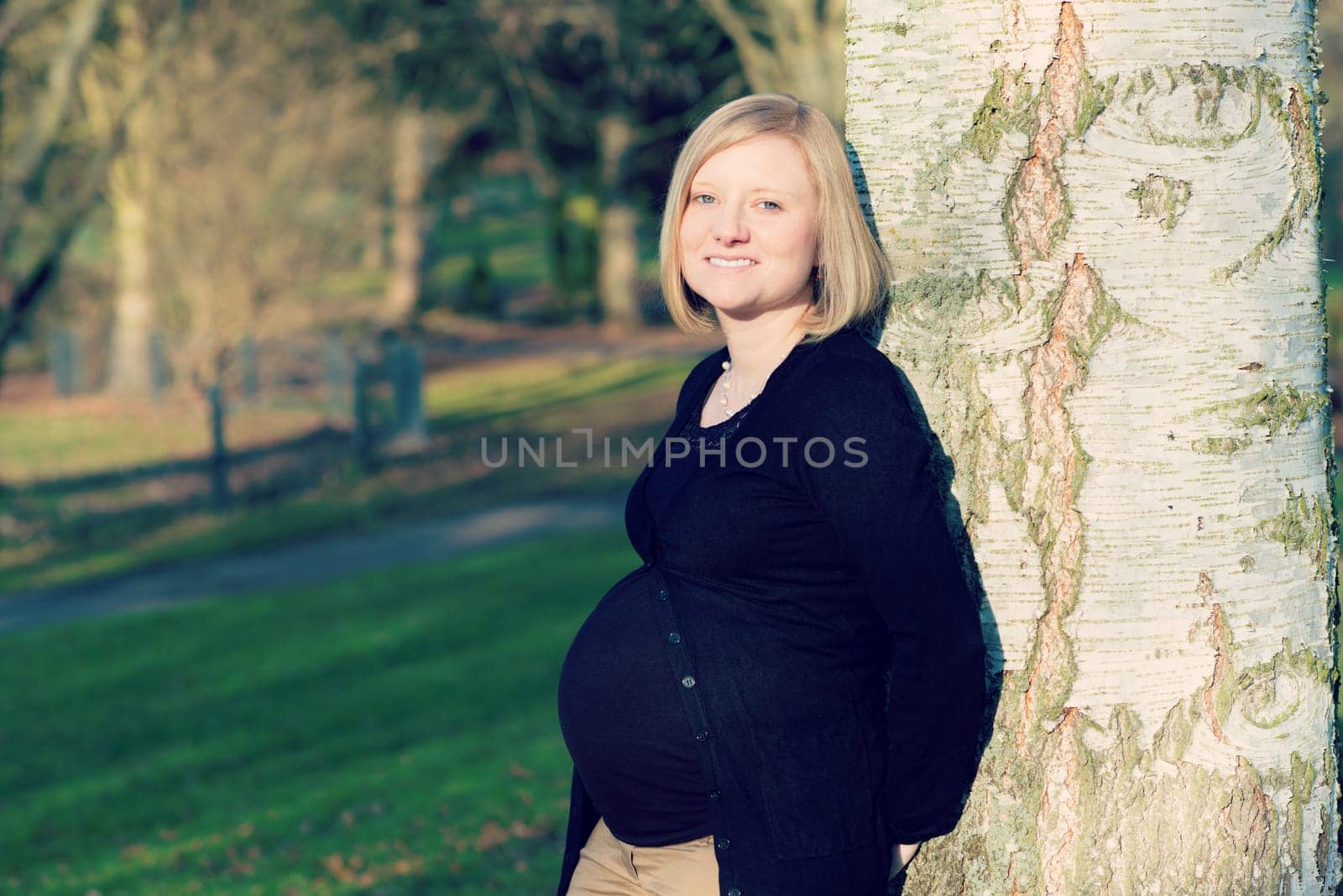 young blond pregnant woman alone  the park