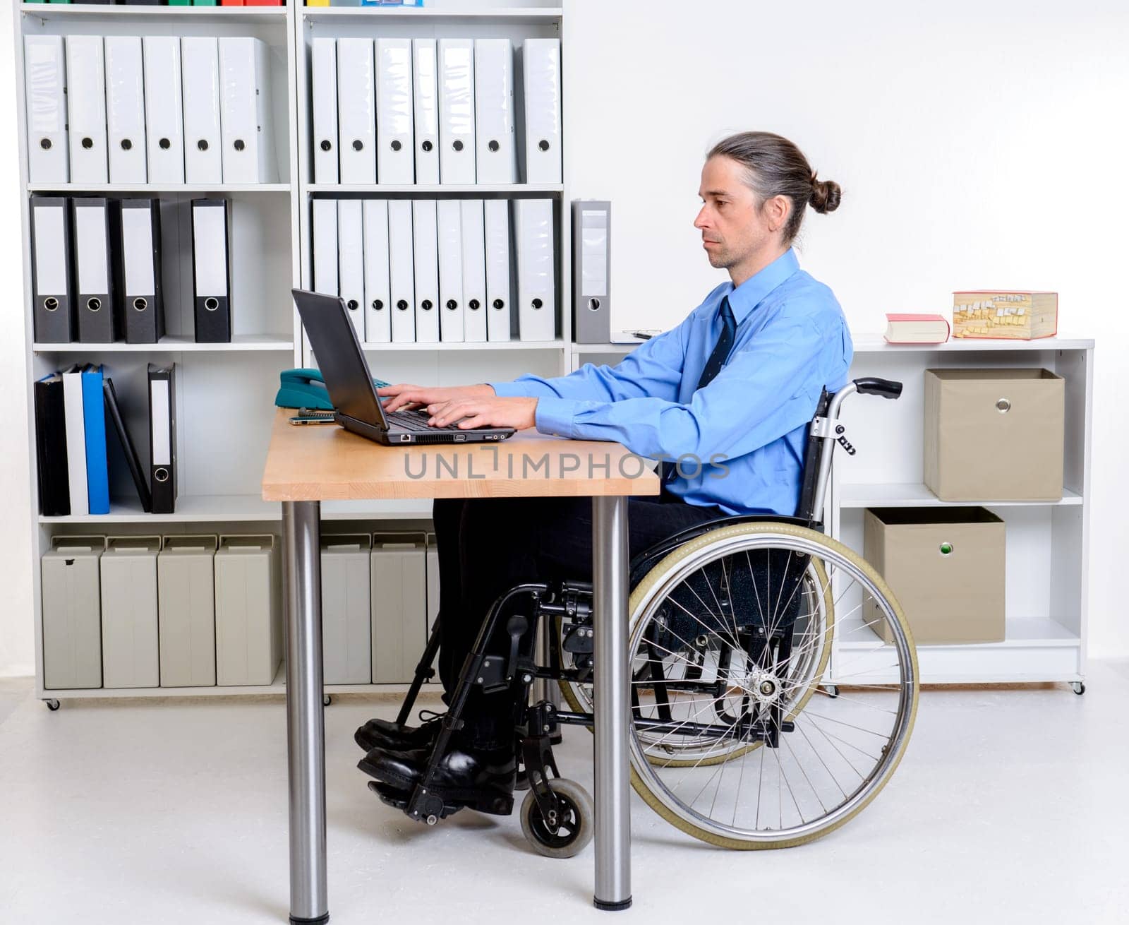 disabled business man in wheelchair working with the computer