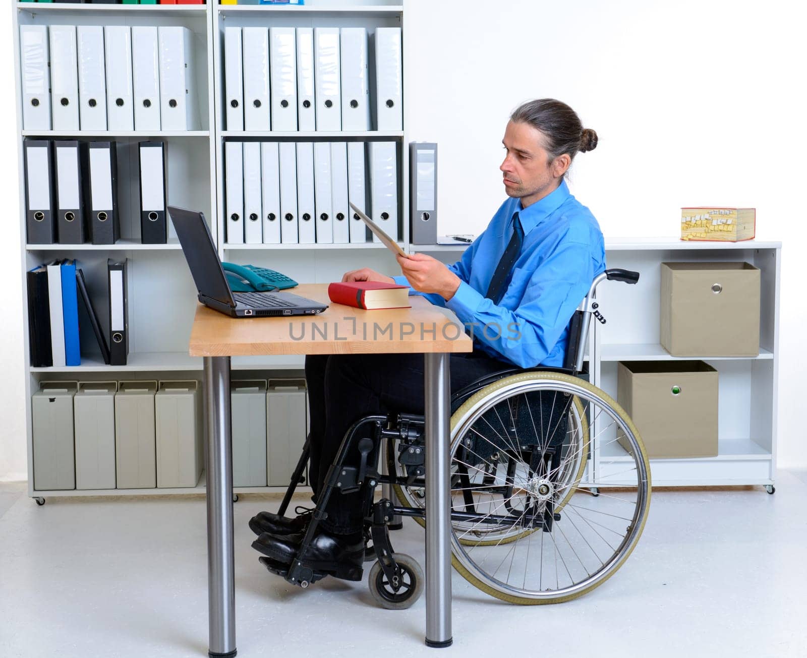 disabled business man in wheelchair using tablet pc