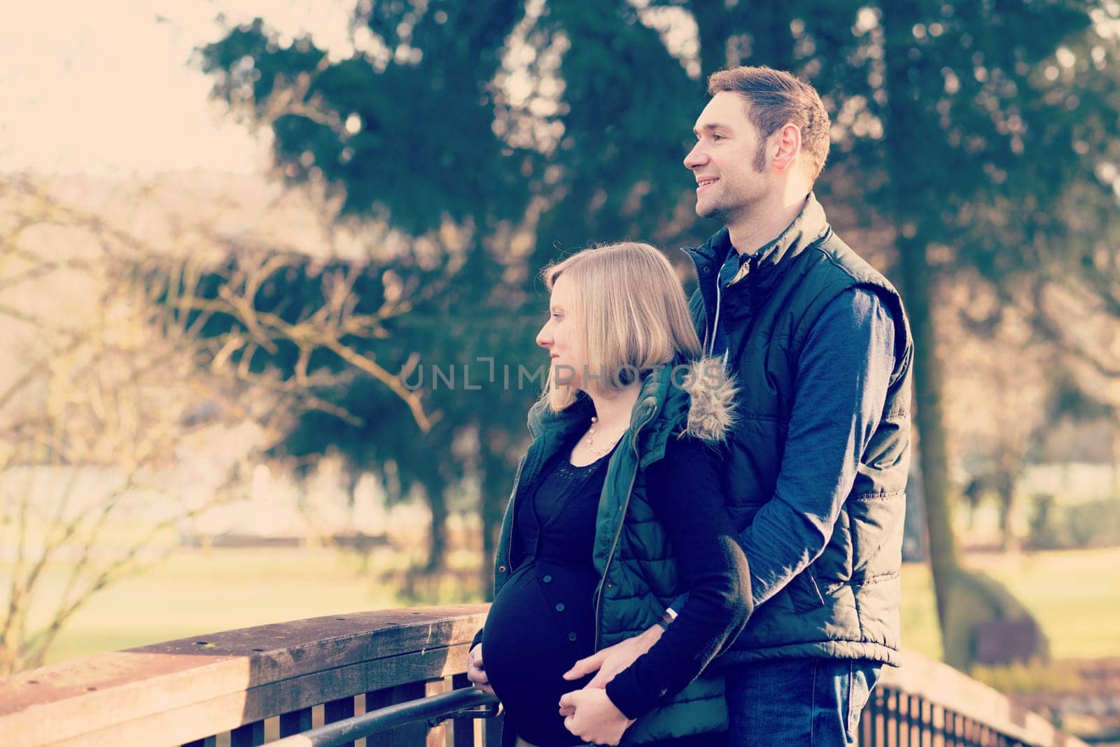 young pregnant woman with her husband in the park