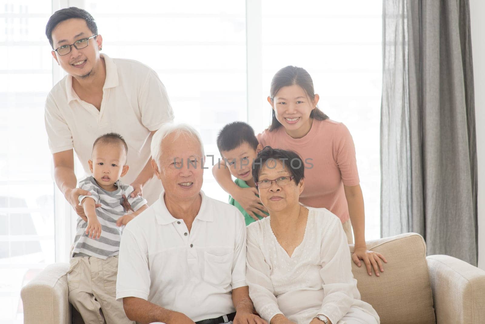 Happy Asian family portrait at home, multi generations indoor lifestyle.