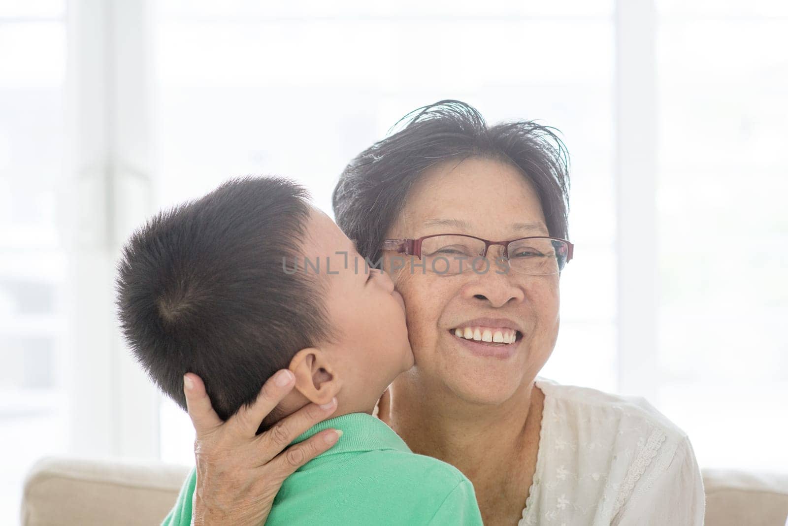 Portrait of happy Asian grandparents and grandson at home, old senior retired people and child indoor lifestyle.