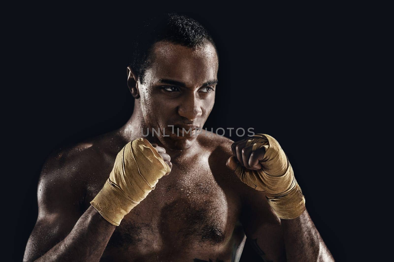 Hand of boxer over black background. Strength, attack and motion concept. Fit african american model. Afro muscular athlete in sport uniform. Sporty man during boxing exercises