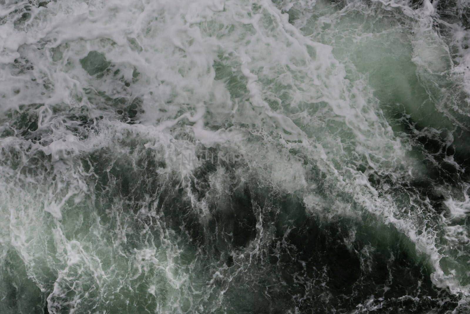 Big water splash seen from above a boat