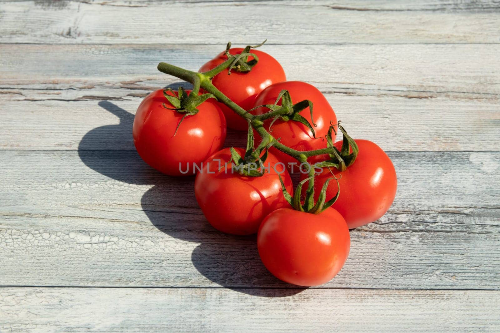 Healthy fresh red ripe tomatoes on wooden table. Outdoor. Concept health.