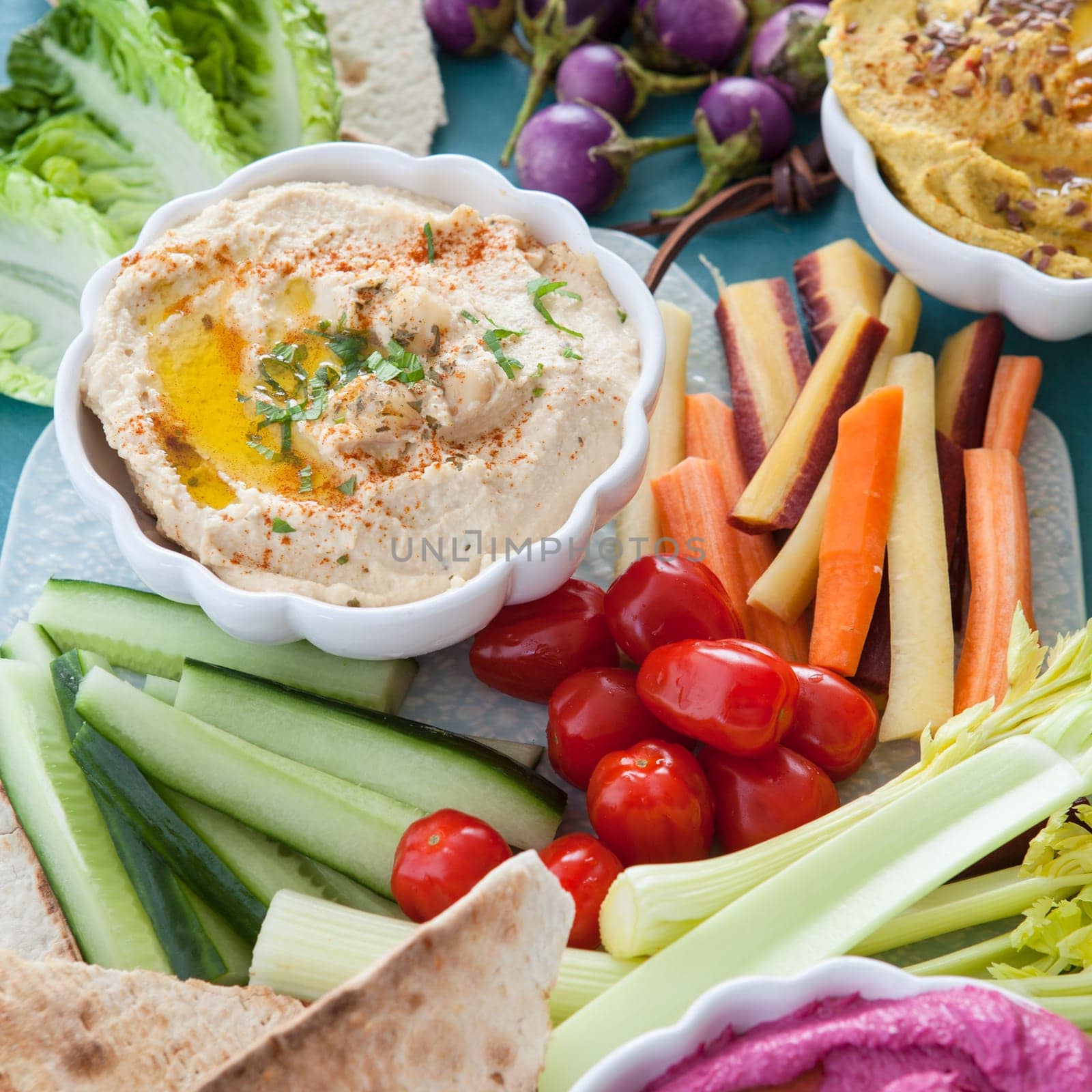 Different varieties of hummus with fresh vegetables