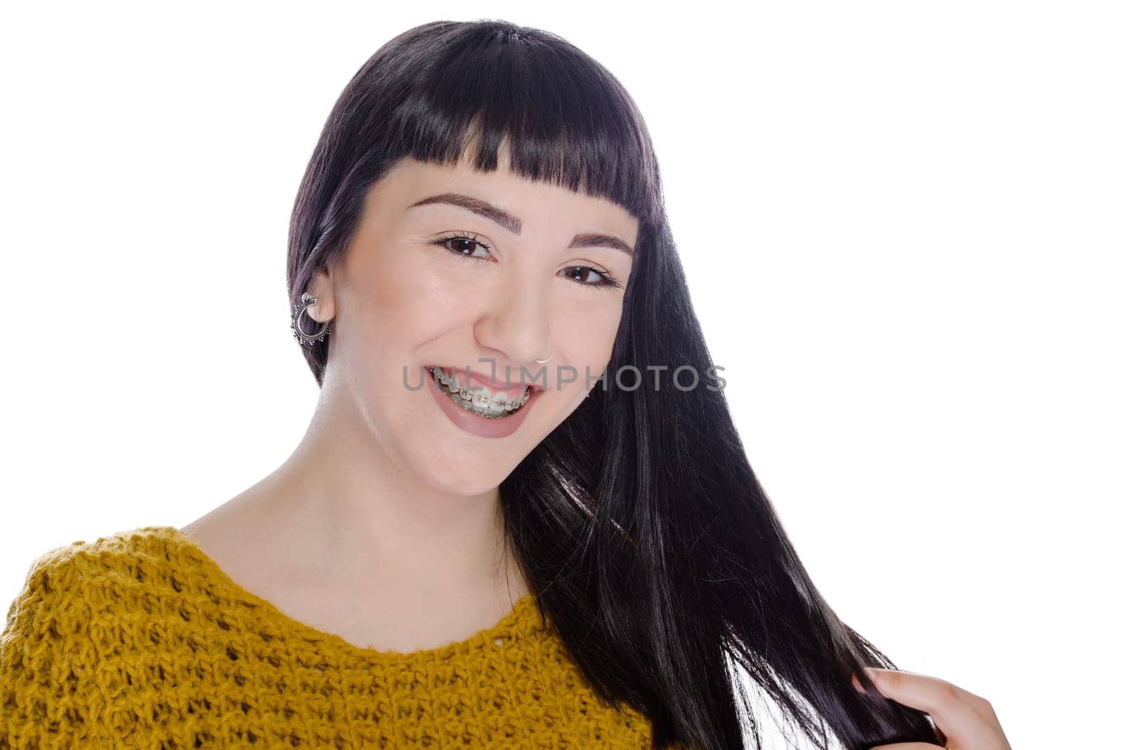 Cute teenager with white background, wearing braces on his teeth.