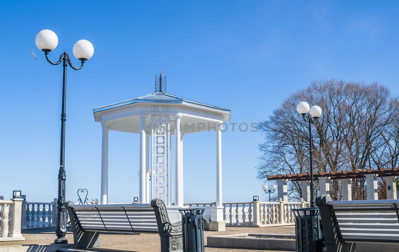 A beautiful romantic gazebo in the park on blue sky background