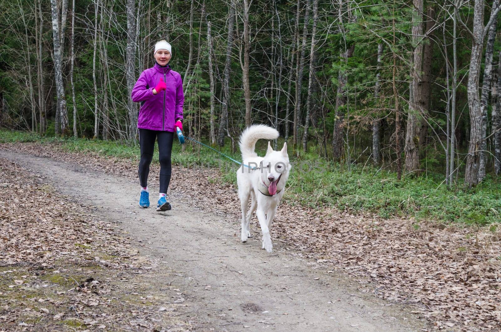 Woman with a dog on a run in the park