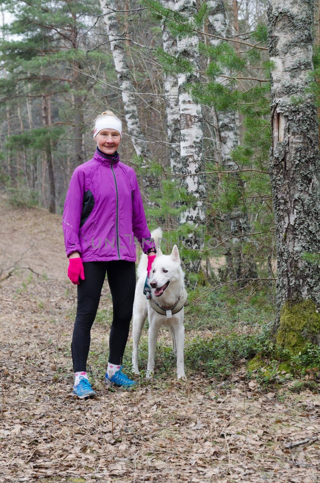 Sporty woman with a dog in the park