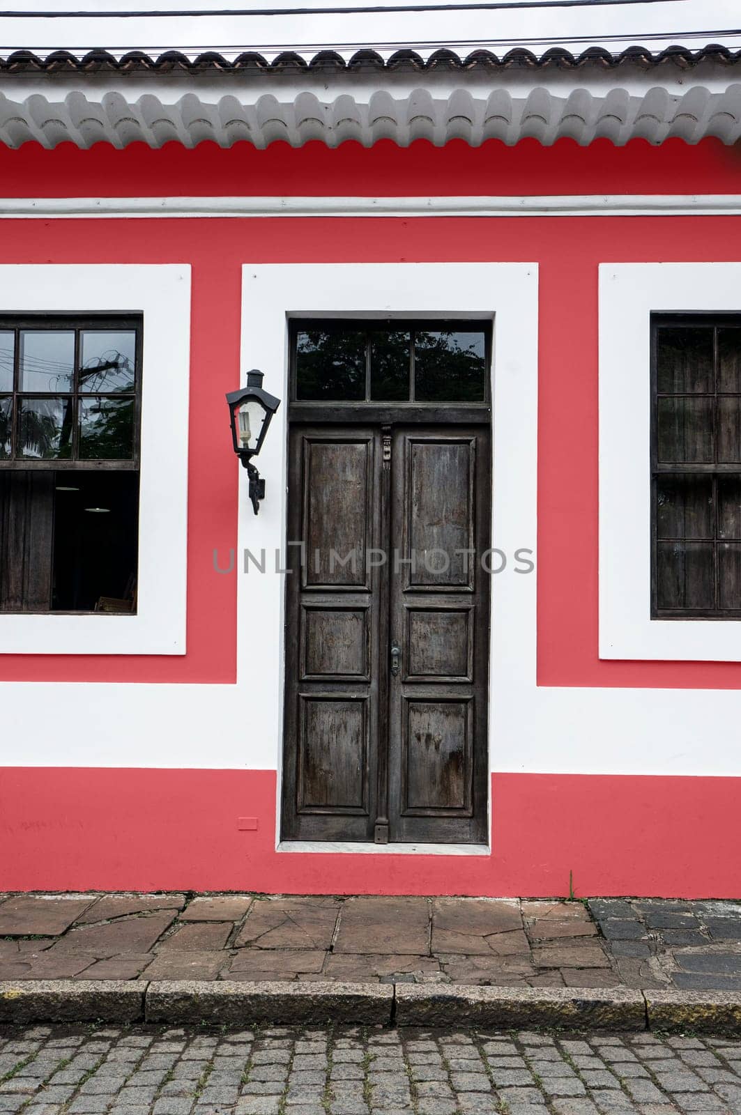city Morretes Brazil old light chandelier design wooden door glass windows red wall