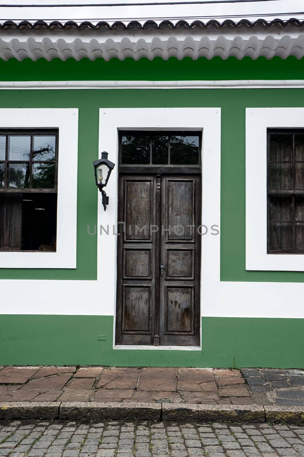city Morretes Brazil old light chandelier design wooden door glass windows green wall
