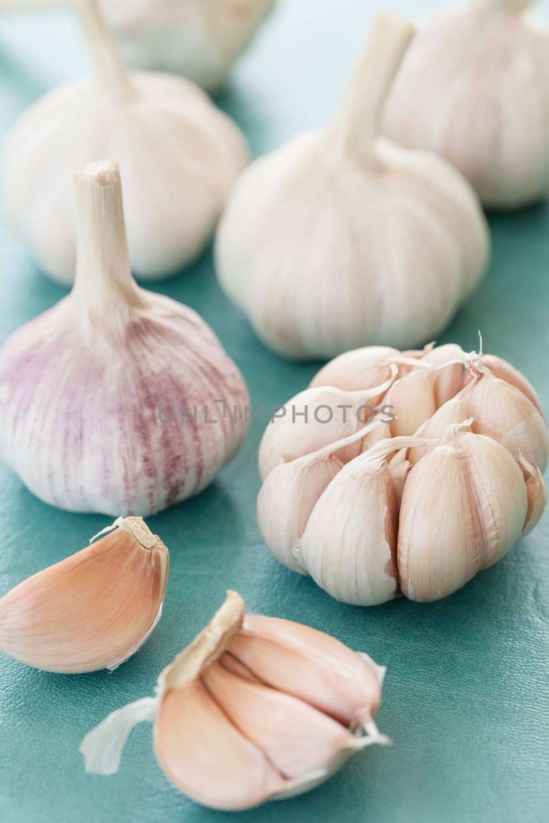 Tubers of fresh garlic on a blue background