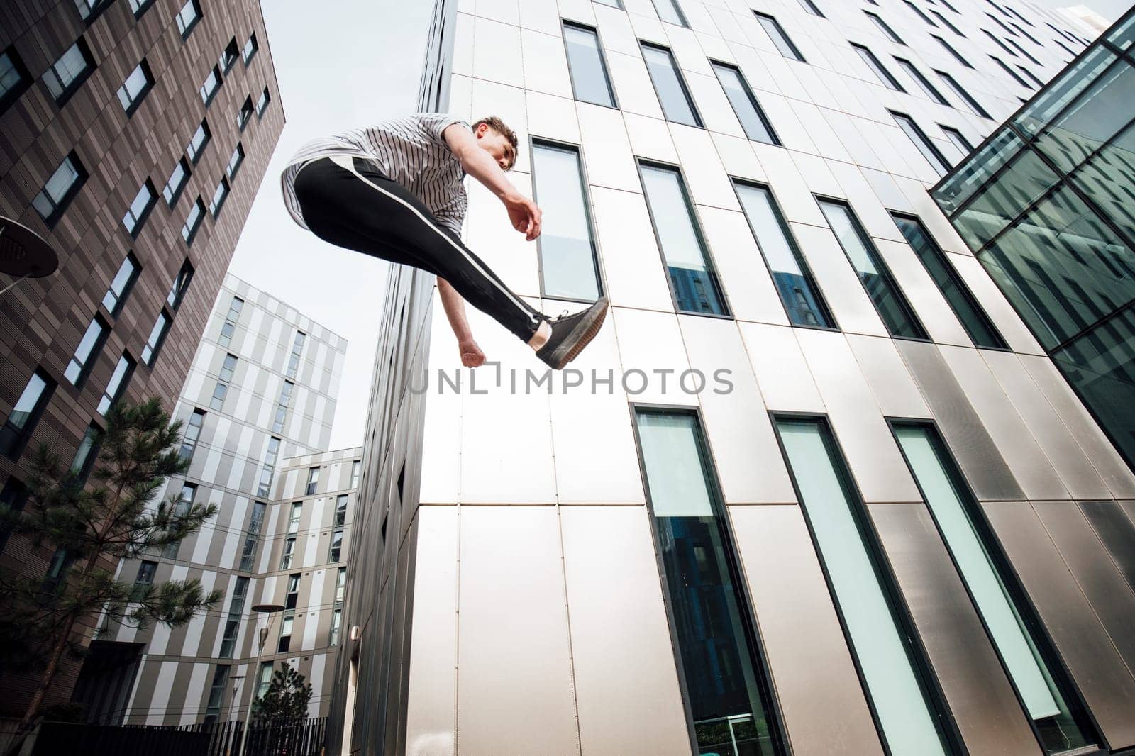 Freerunner is jumping between walls in the city.