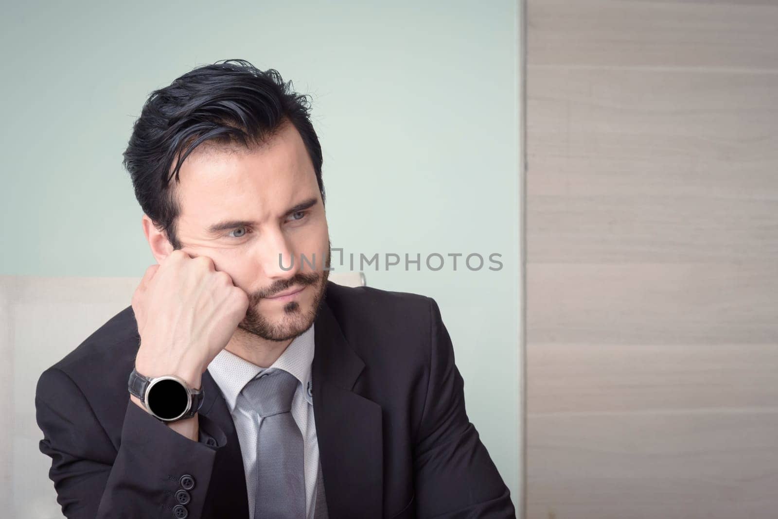 Young depressed stressed frustrated businessman working at office