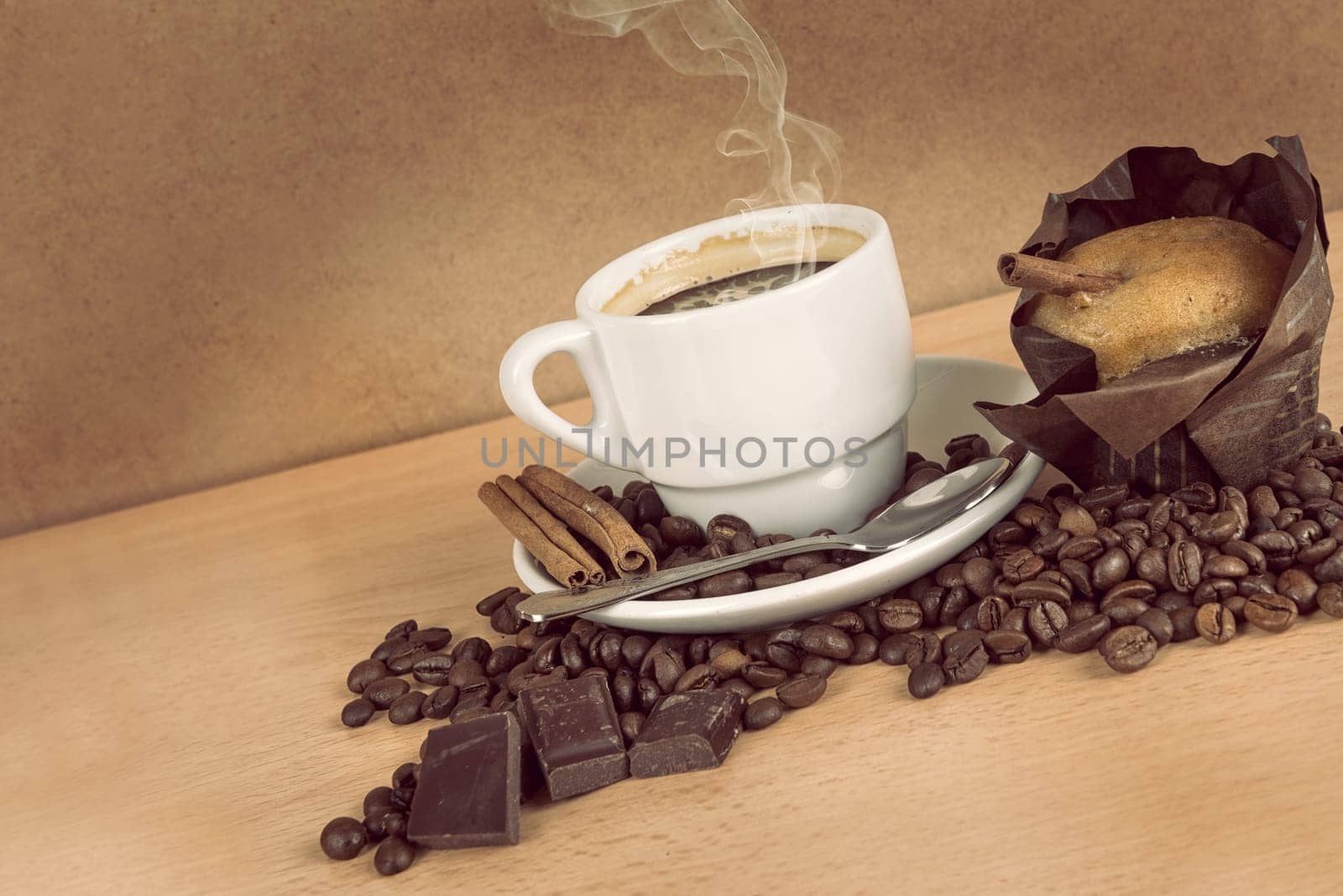 coffee cup with coffee beans, chocolate and muffin
