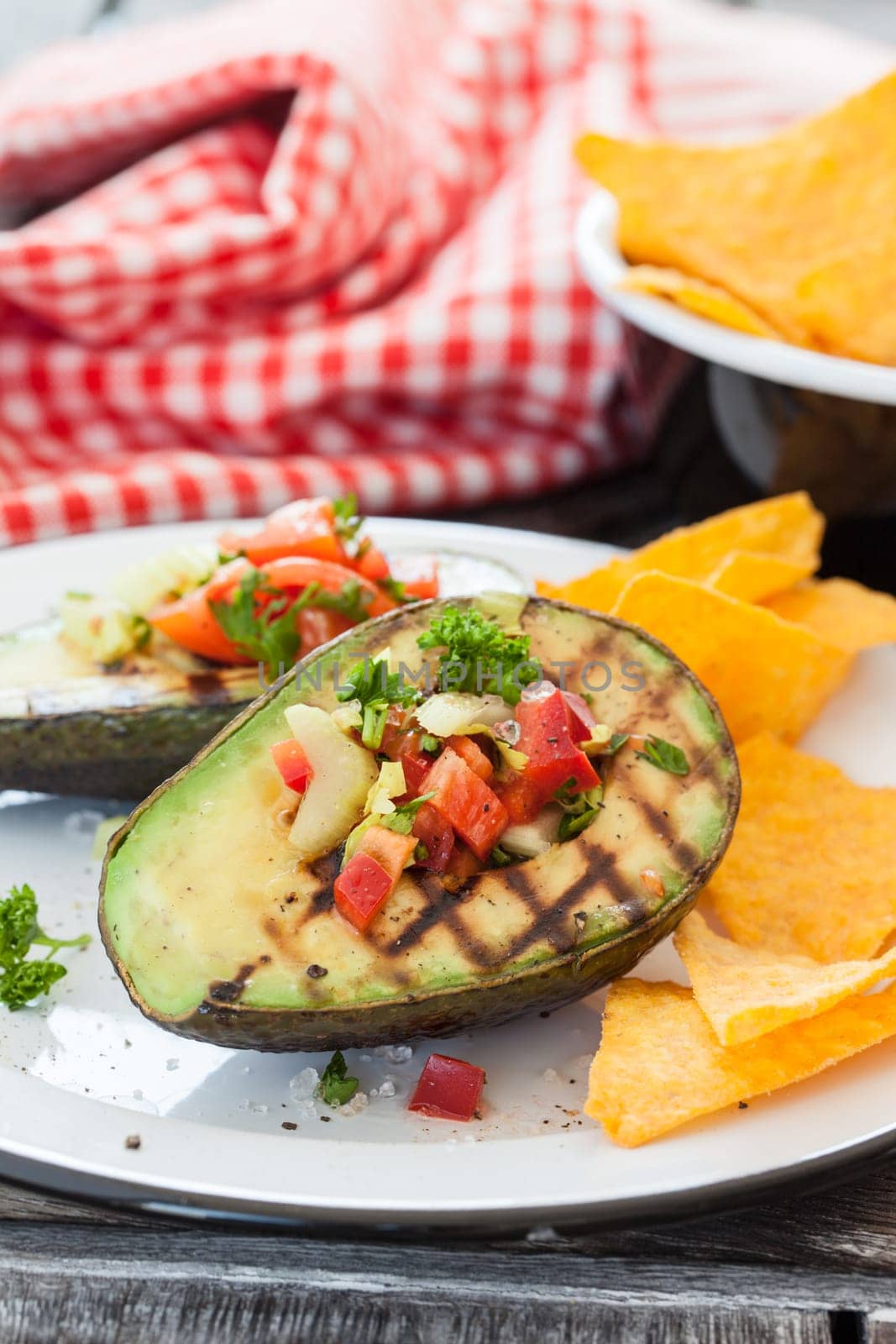 Grilled avocado with vegetables and taco chips