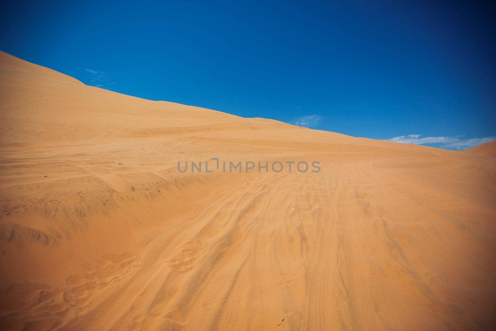 Sands dunes in the desert and blue sky.