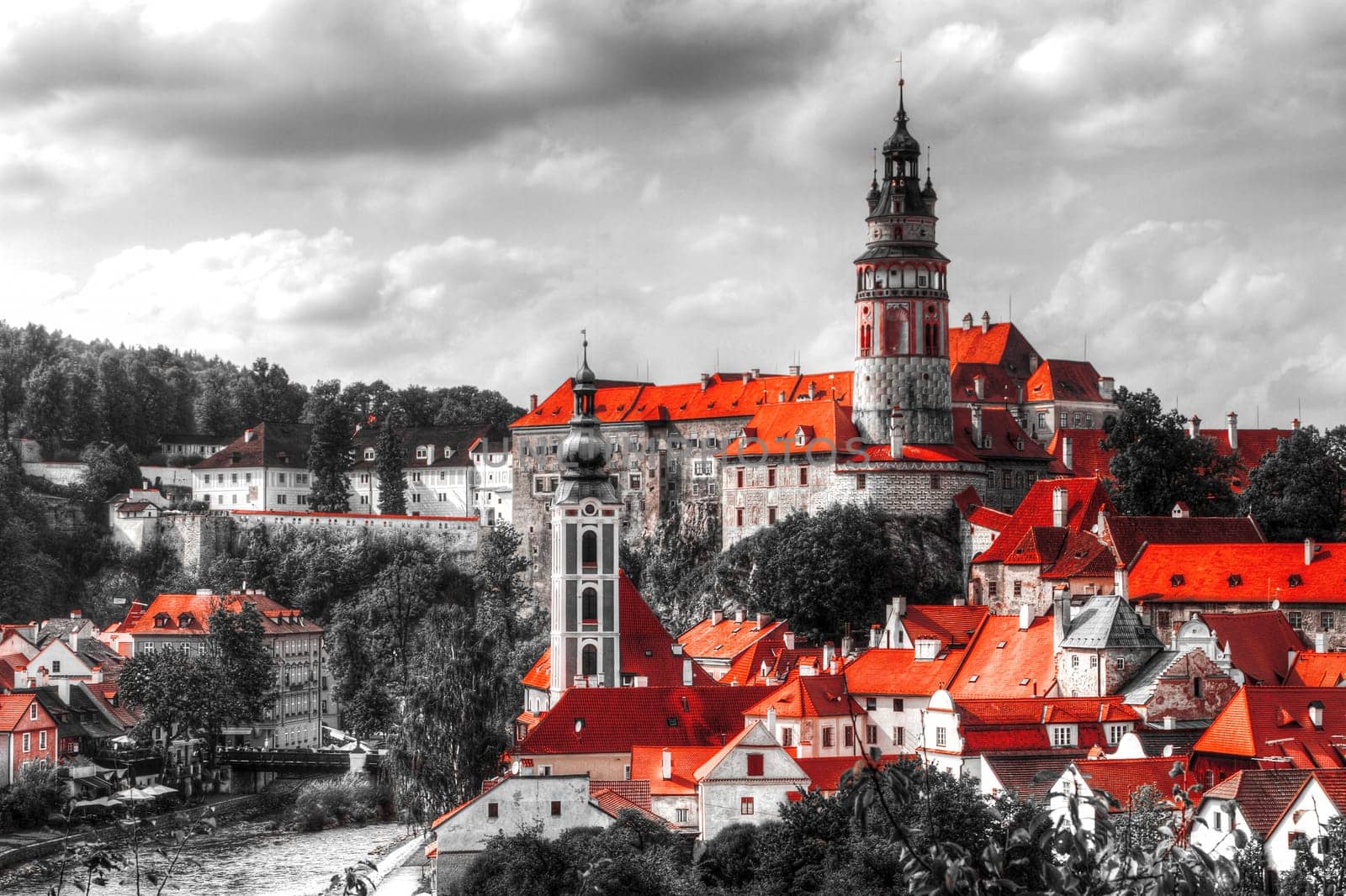 Black and white photo with the color red. View on Cesky Krumlov,Czech republic