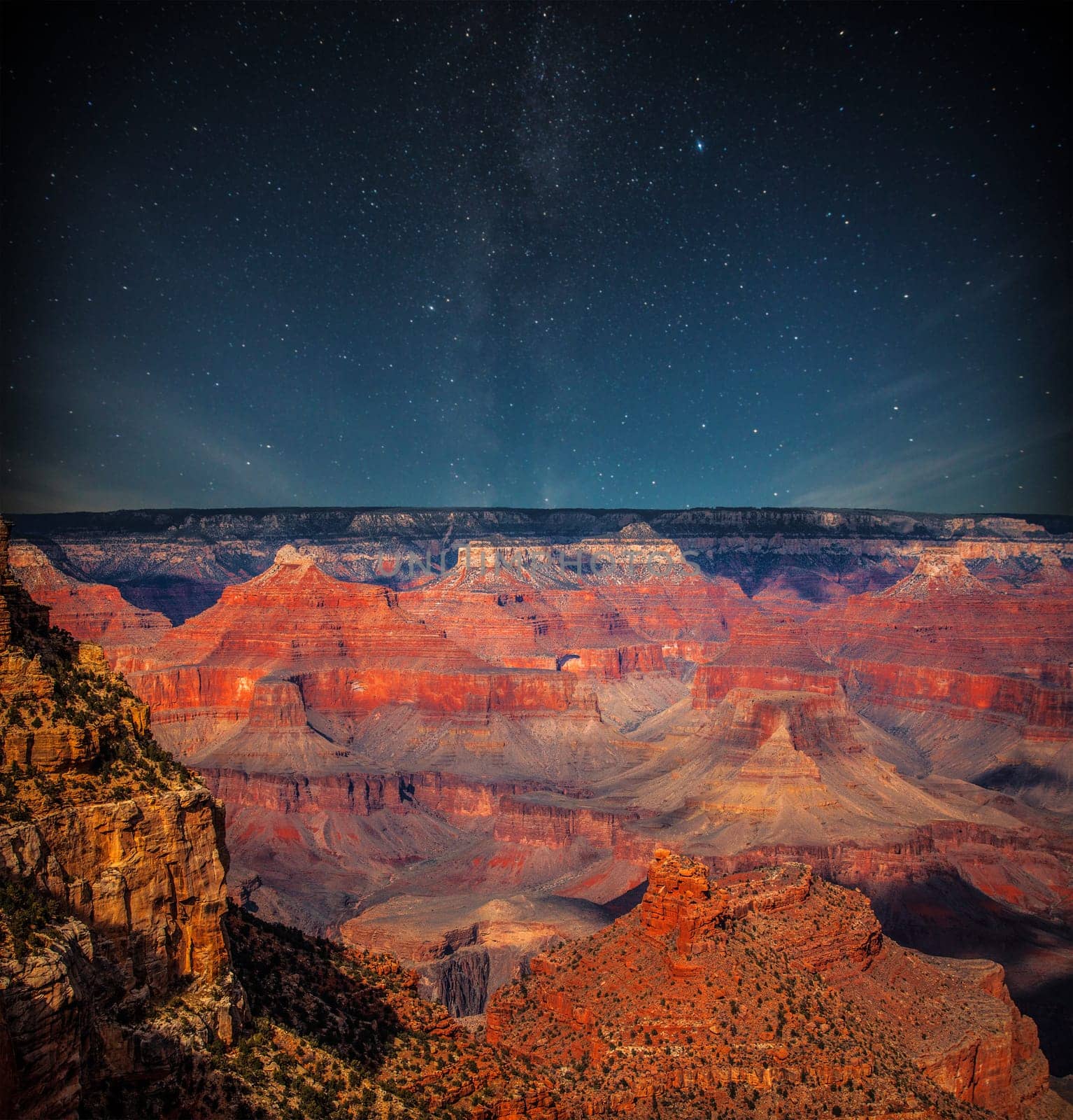 Grand Canyon at night under the light of the stars in the sky