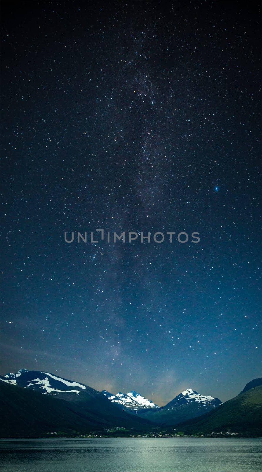 stars shine in the sky over the fjords. Milky Way