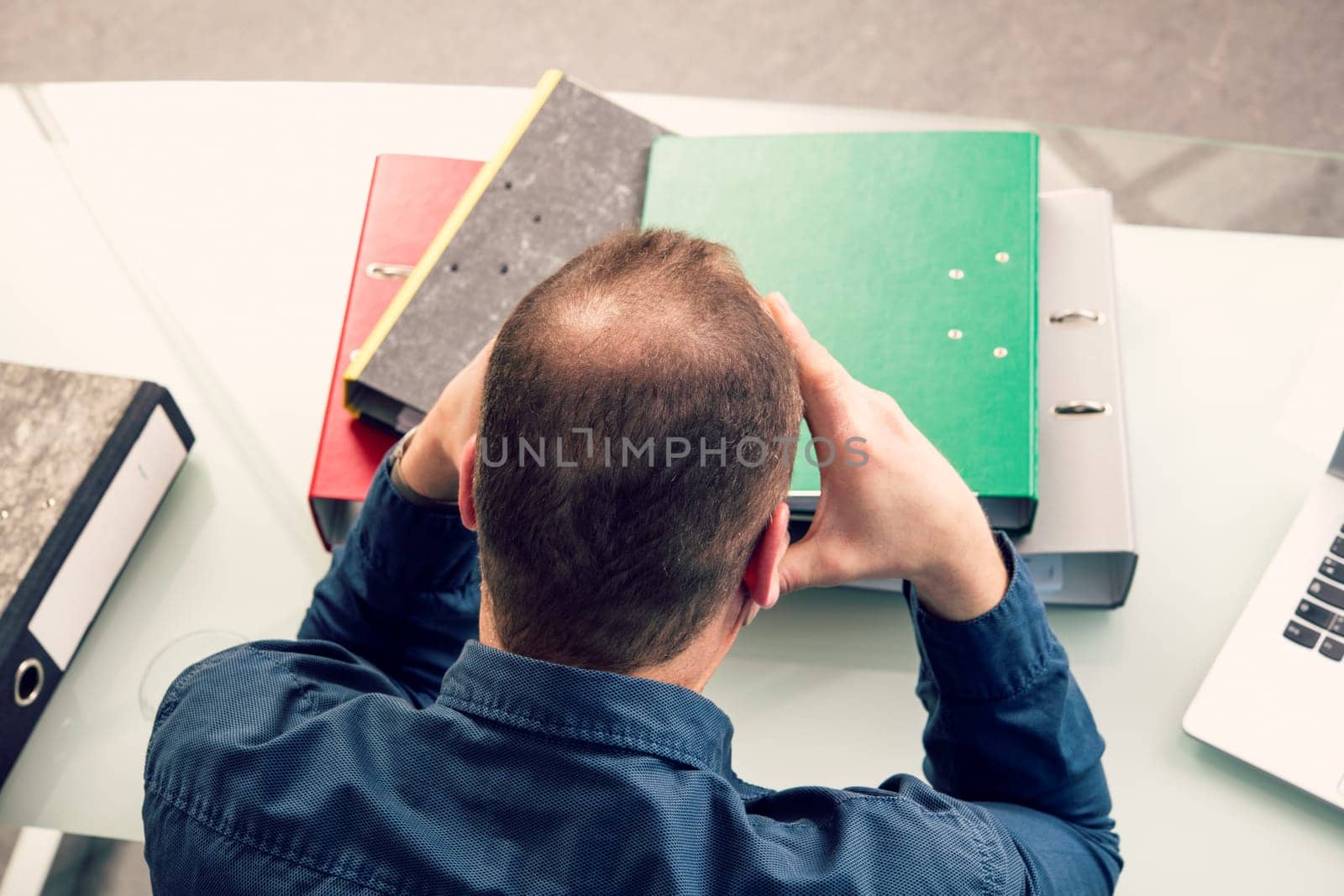 young business man with a lot of work at his desk
