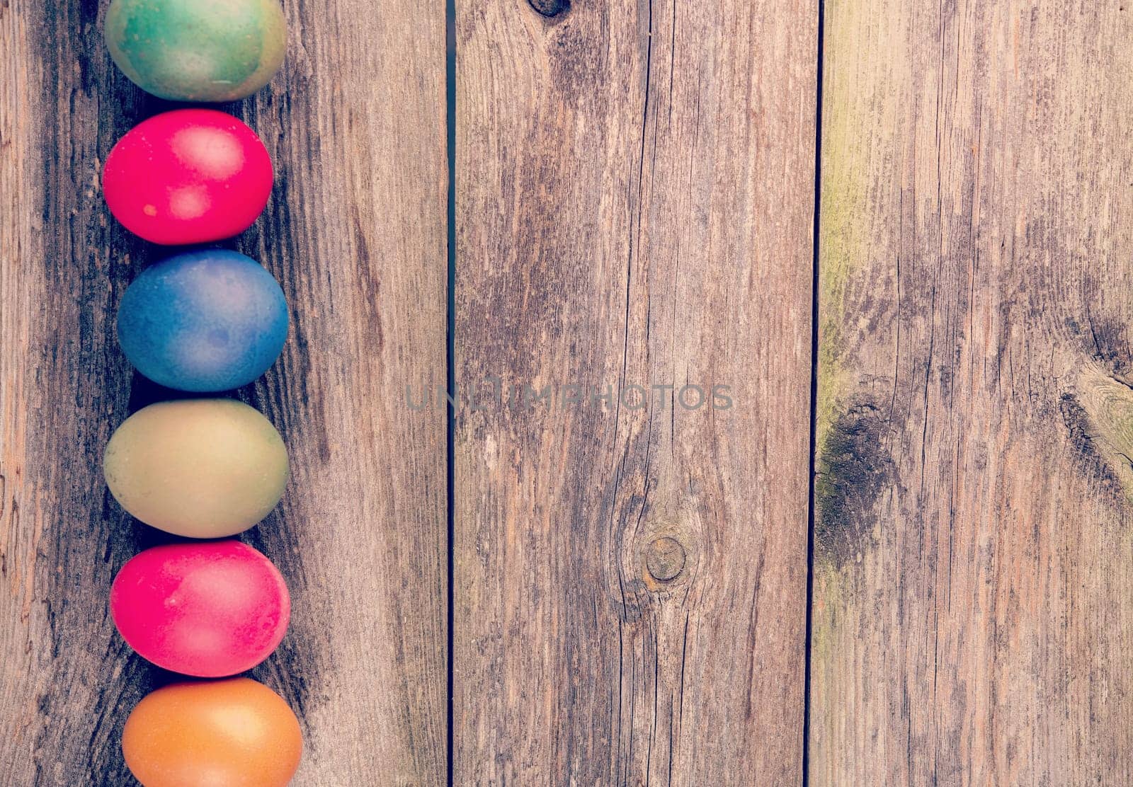 different easter eggs on gray wooden ground