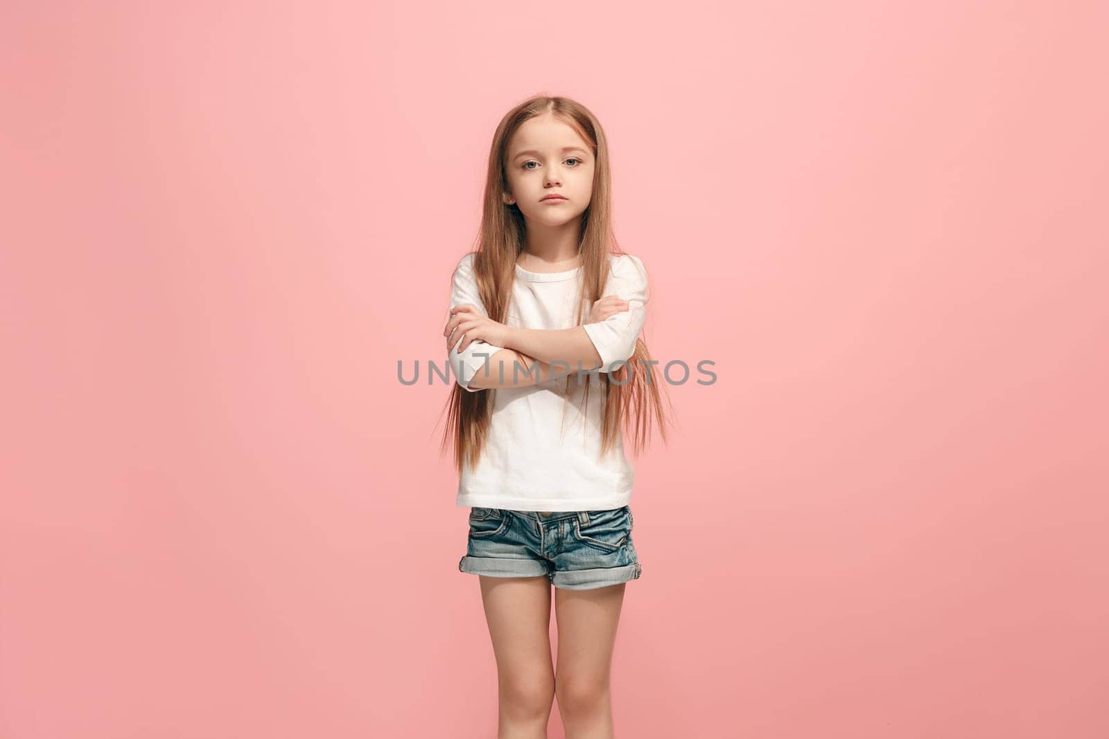 Serious, sad, doubtful, thoughtful teen girl atanding at studio. Human emotions, facial expression concept