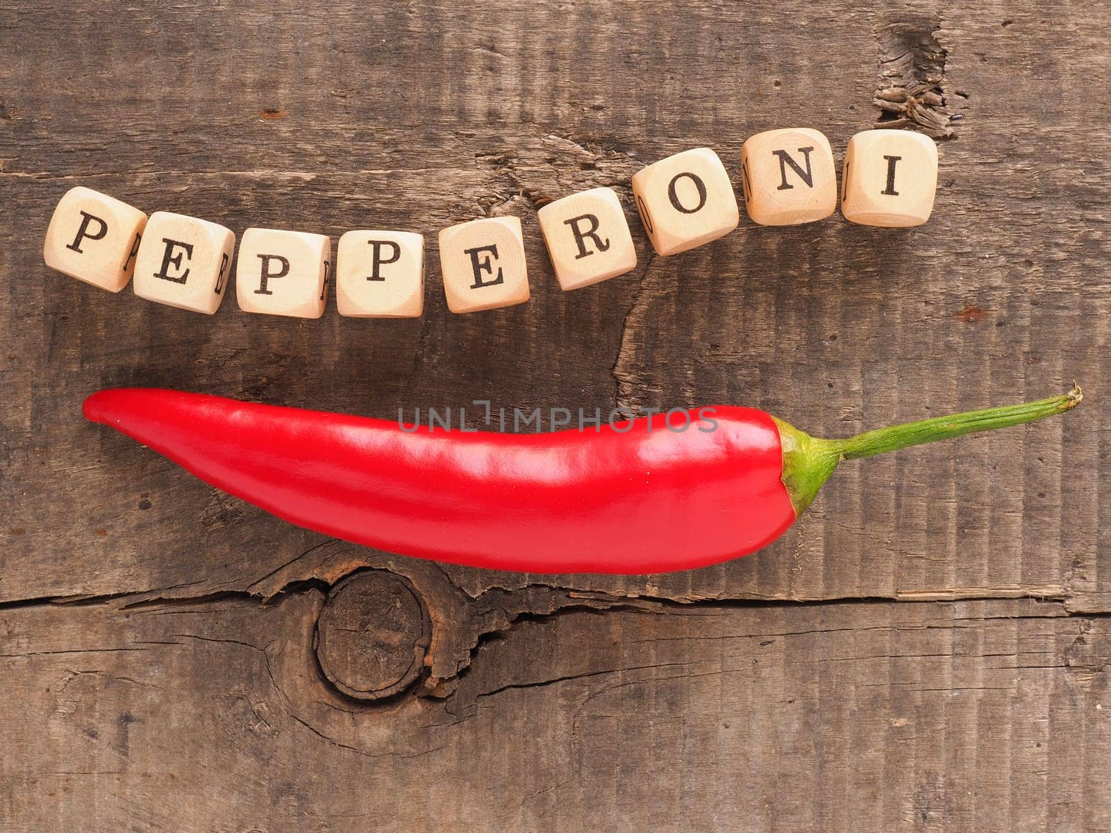 Fresh organic pepperoni on a rustic wooden kitchen table